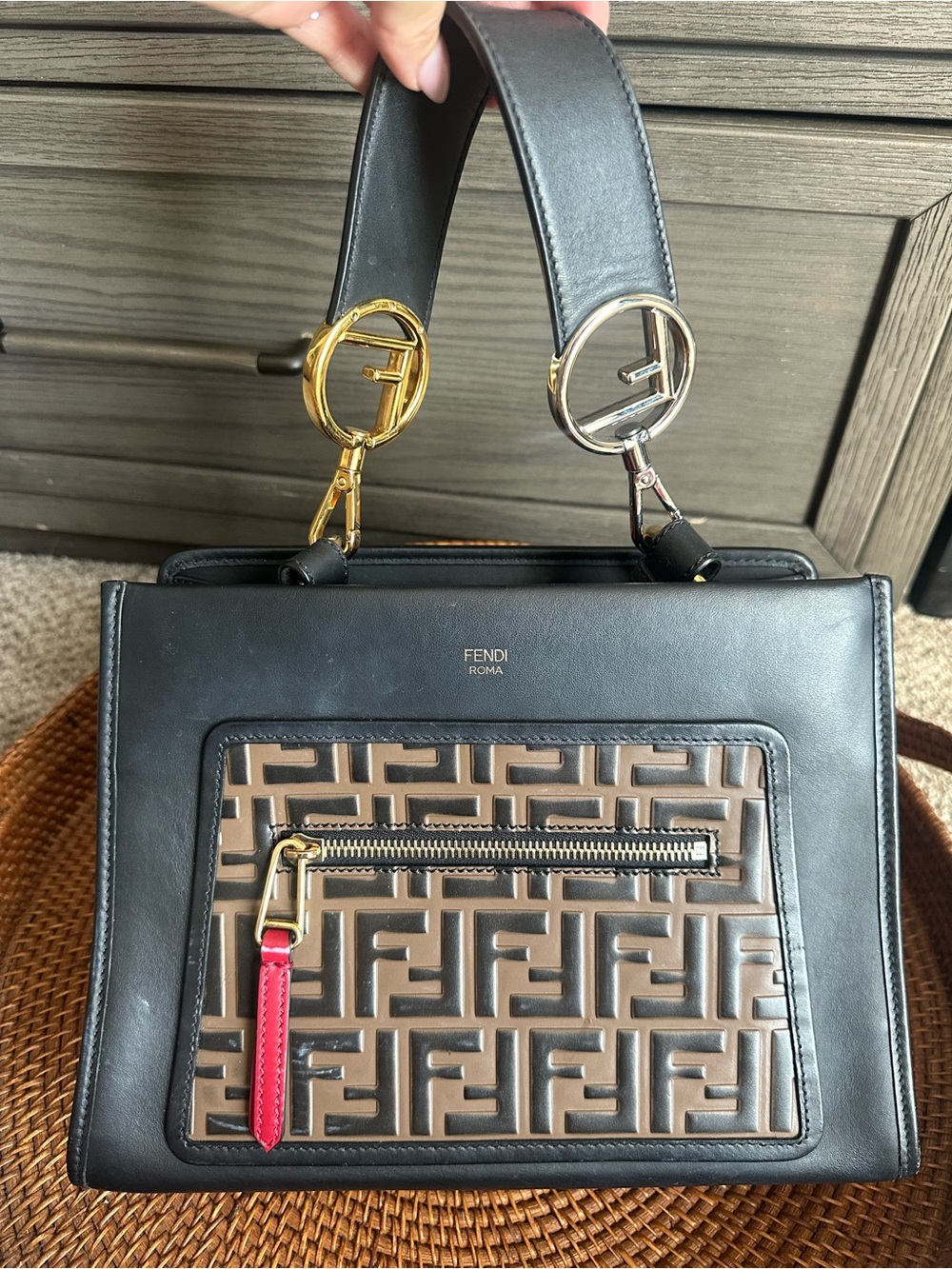 Fendi Black and Brown FF-Embossed Leather Top-Handle Bag with Red Zip Pull.